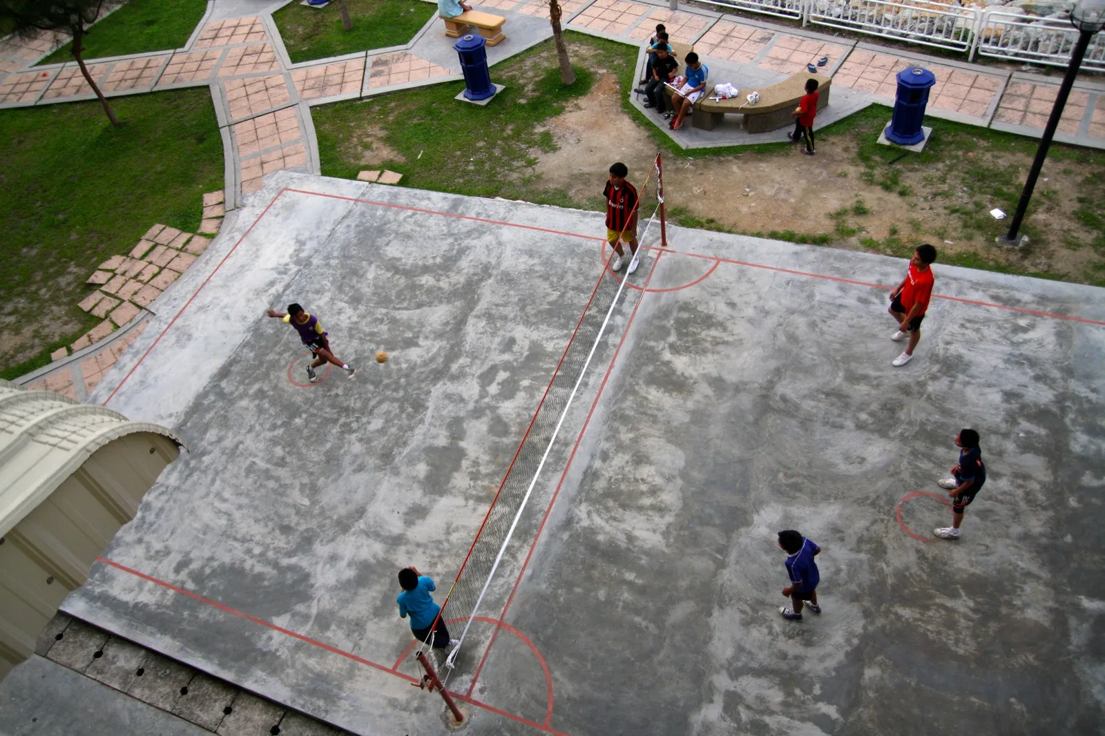 Players on an outdoor sepak takraw court. The picture does not show the Pedigo Park courts.