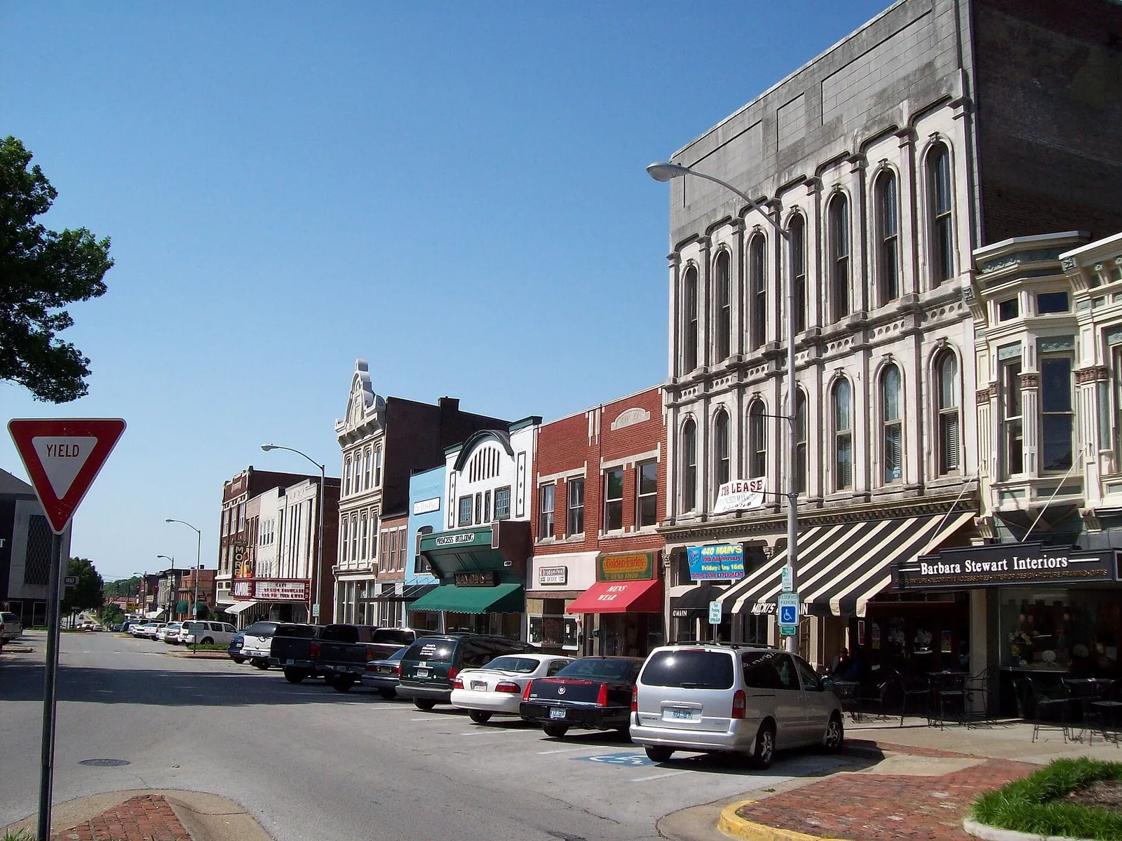 Historic storefronts along Fountain Square in downtown Bowling Green, with The Capitol's marquee down the block