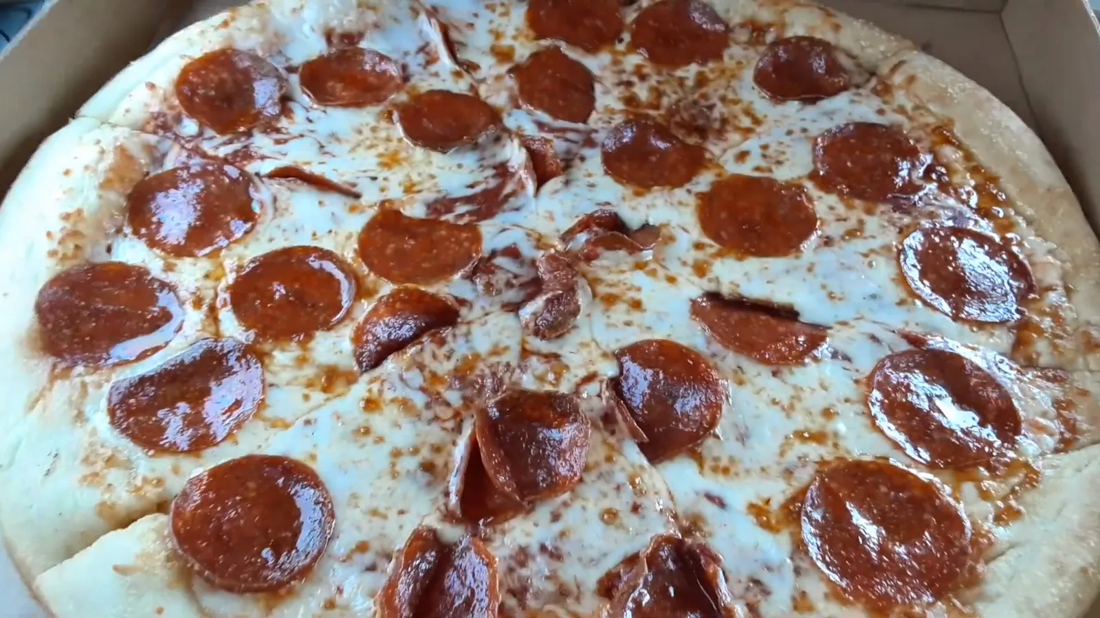 A pepperoni pizza in a delivery box